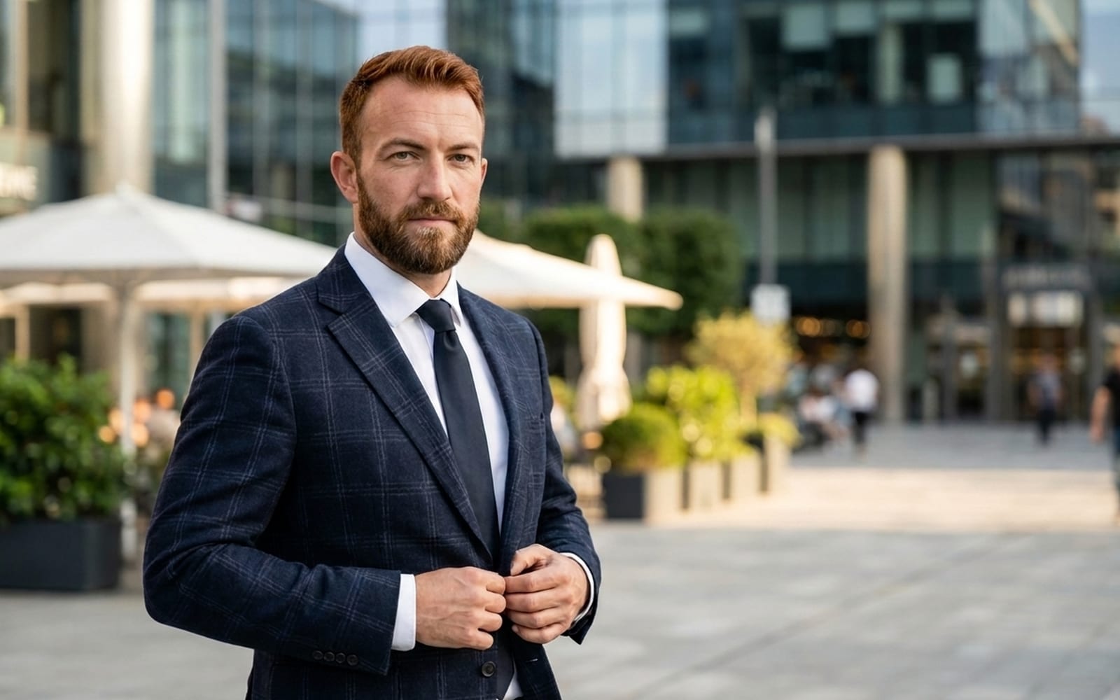 An executive standing outside a glass office building