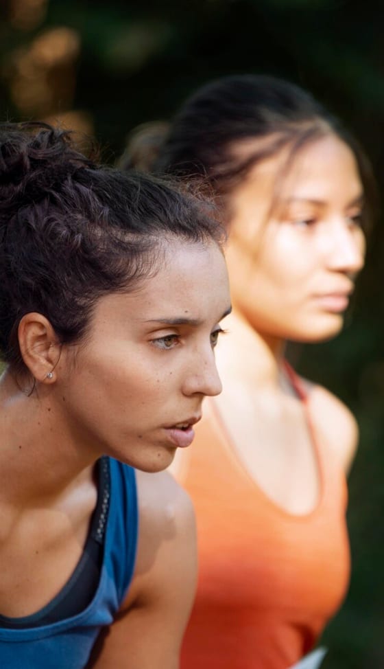 Two athletes catching their breath during a training session